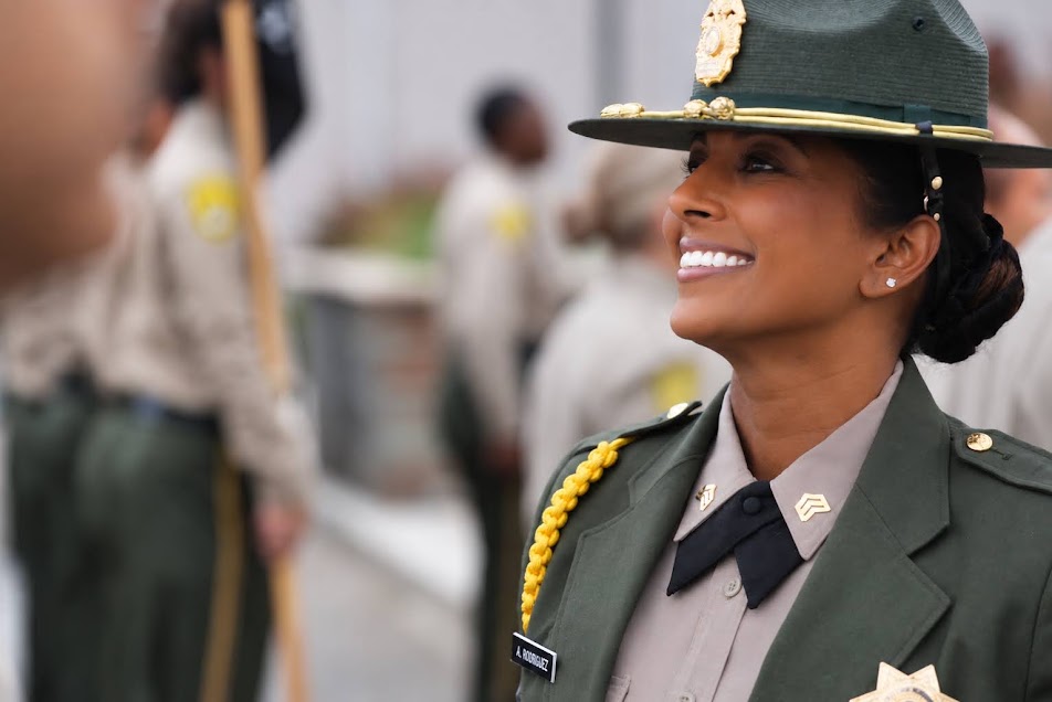 A CDCR staff member smiles during the graduation.