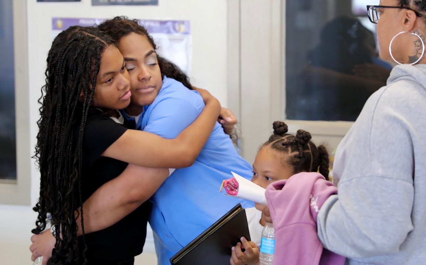 CCWF CALCTRA graduate hugs a family member after the ceremony.