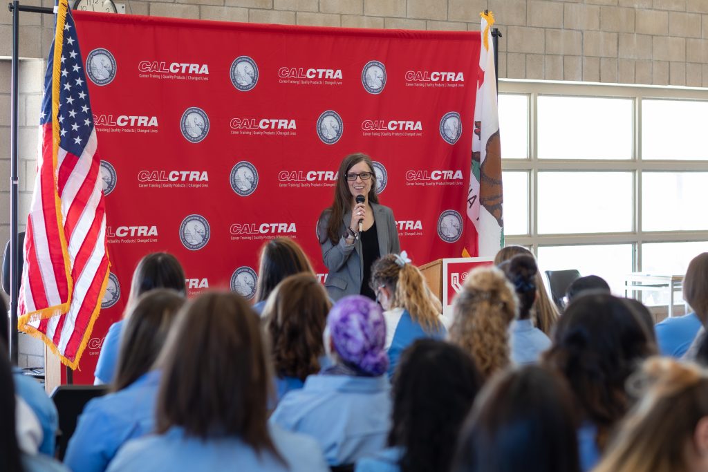 CALCTRA Director Suzie Changus speaks at the graduation ceremony at CCWF.