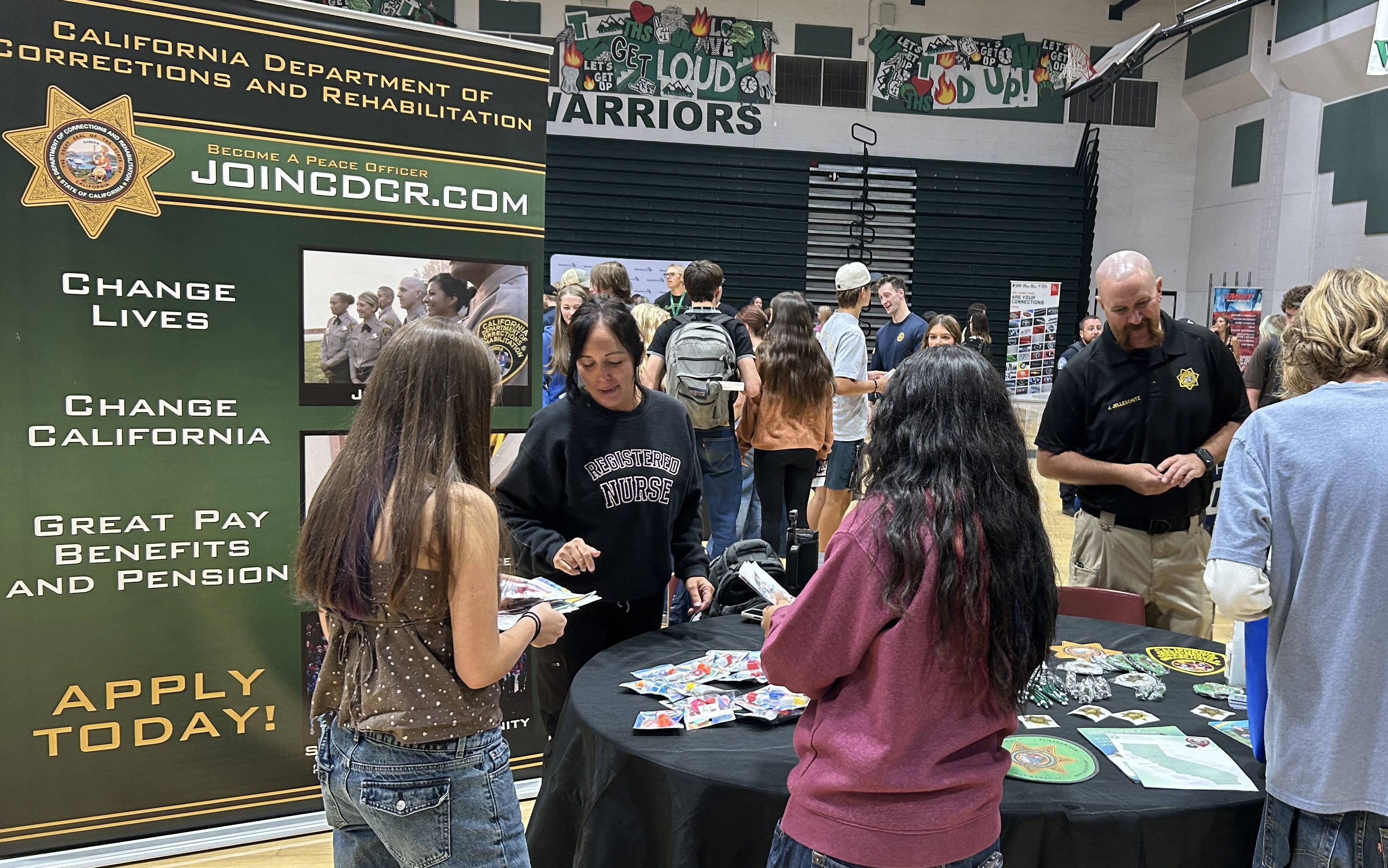 A CCI registered nurse and a custody staff member talk to Tehachapi high school students during career day.
