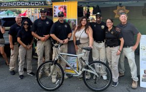 CDCR team with donated bike and attendee at State Fair