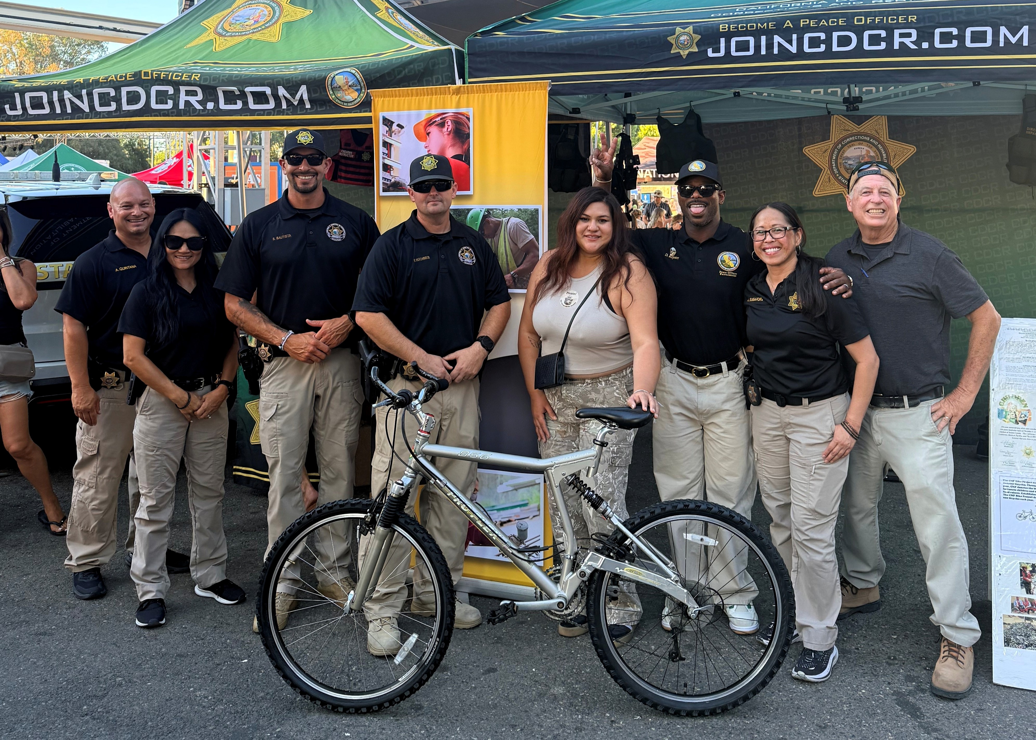 CDCR team with donated bike and attendee at State Fair