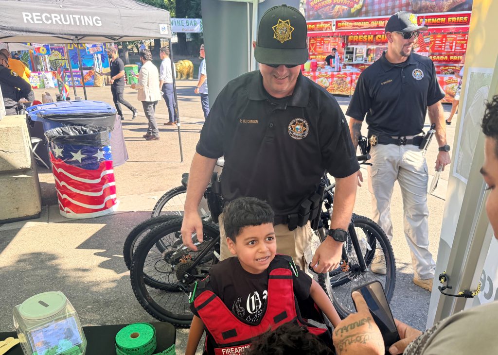 CDCR team with young attendee at State Fair