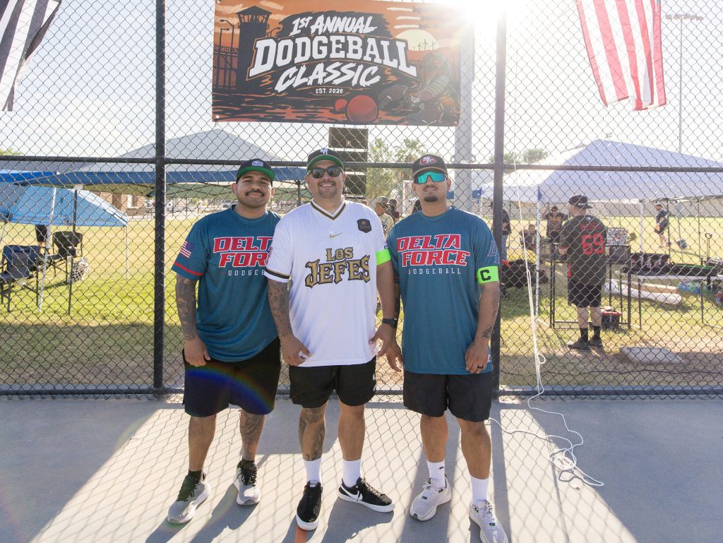 Three staff members pose at the tournament.