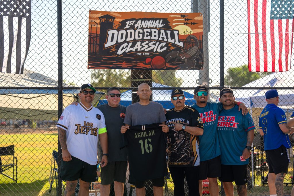 Officer Aguilar being presented with a custom sports jersey.