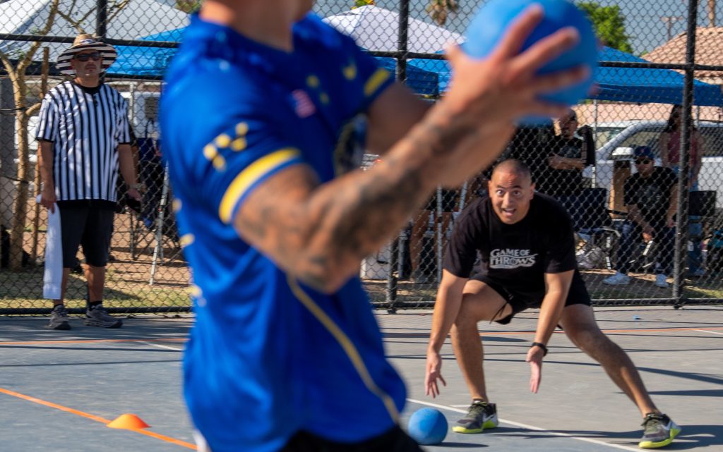 A staff member realizes he's in the line of sight of a ball.