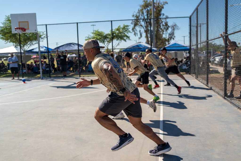 Team members rush toward the center of the court.