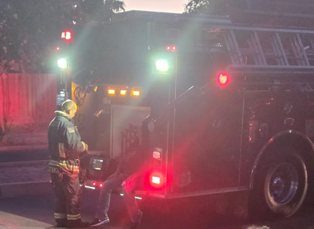 DAPO Agent M Sherman being evaluated by firefighters after a house fire, July 2026.