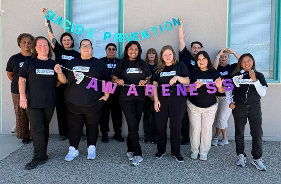 Mental Health office technicians during LAC Twin Day. They are holding letters spelling out Suicide Awareness.