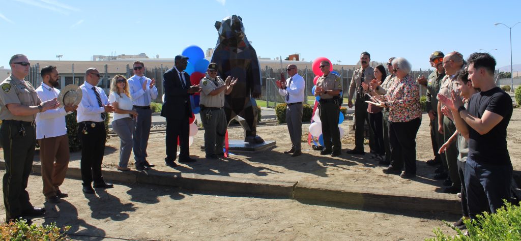PVSP staff with metal sculpture