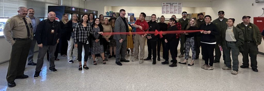 Ribbon cutting with staff at newly renovated CCI cafeteria
