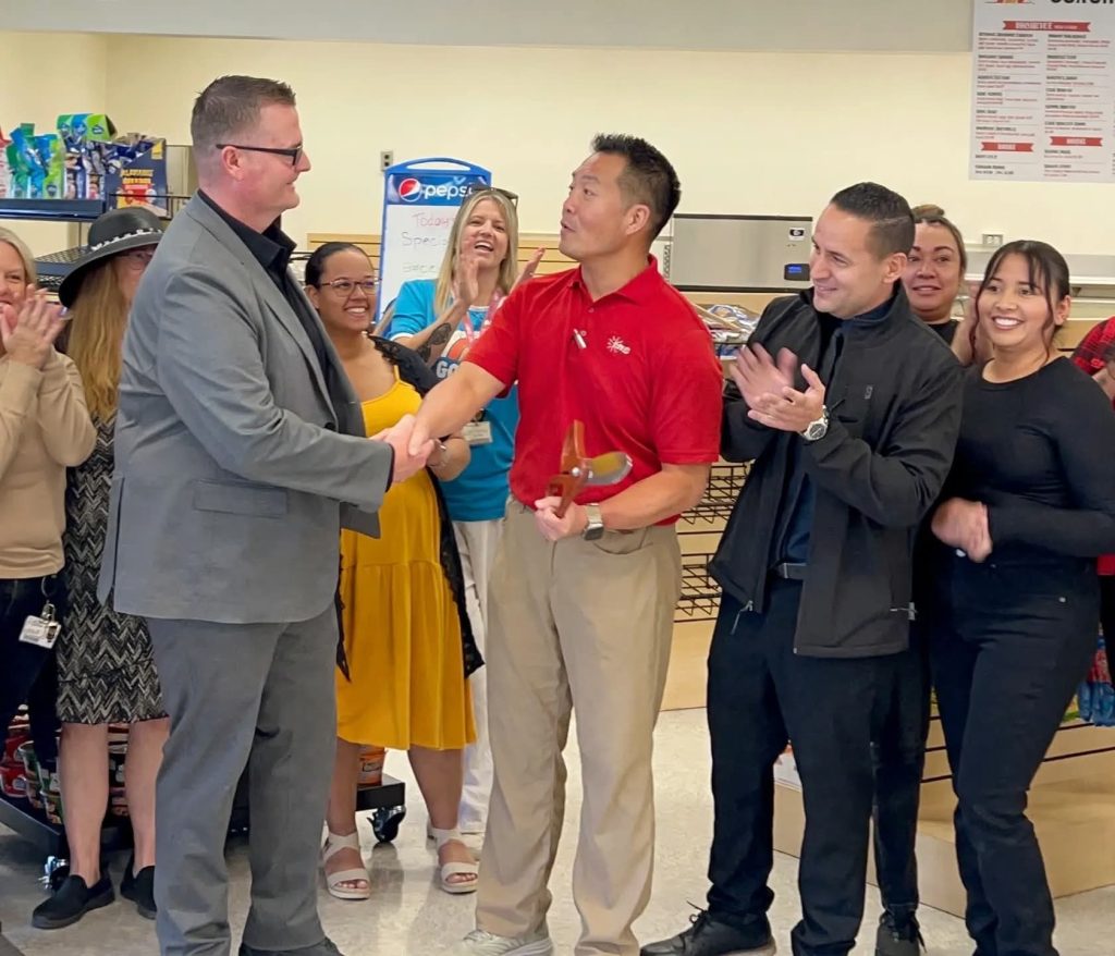 Opening ceremony handshake at newly renovated CCI cafeteria