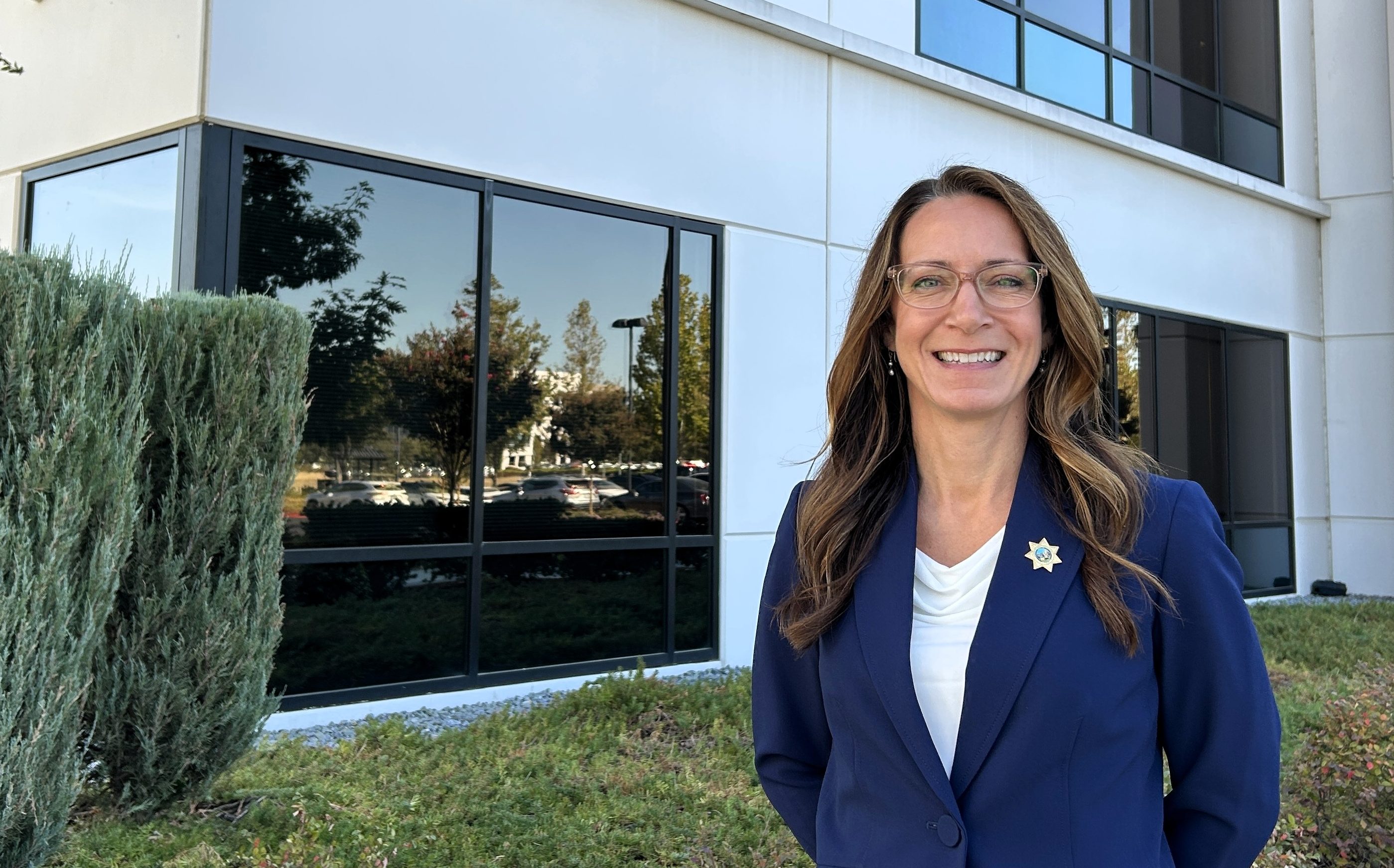 CDCR Undersecretary of Administration, Jennifer Barretto, stands in front of C Building at Elk Grove headquarters. She's retiring at the end of September.
