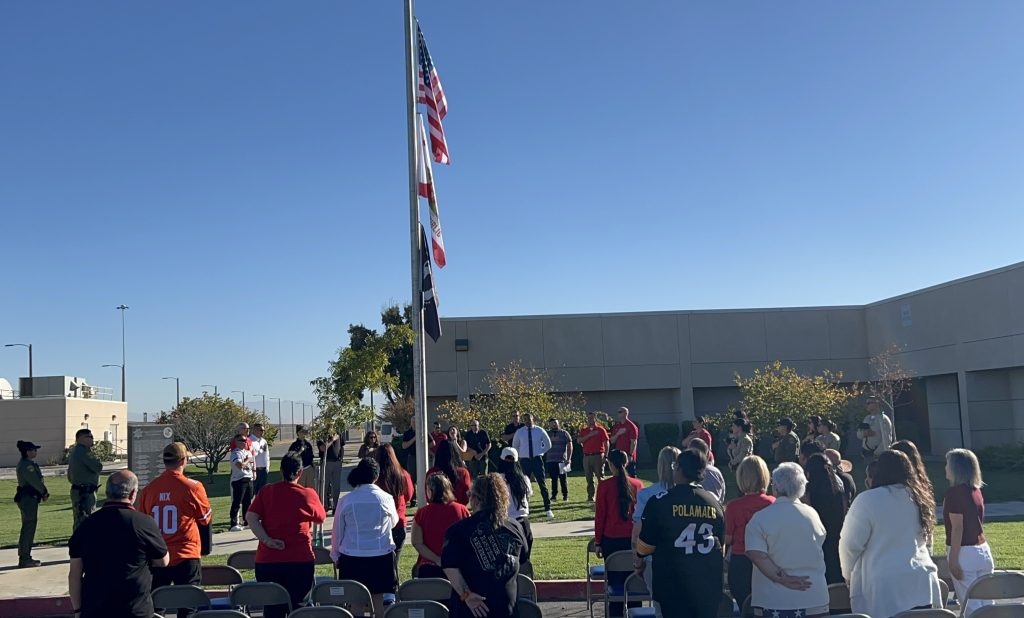 Staff gather around the flagpole at Valley State Prison in Chowchilla.