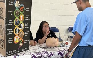 An incarcerated person learns more about how to administer Narcan medication to someone who has overdosed during the Valley State Prison health and wellness fair.