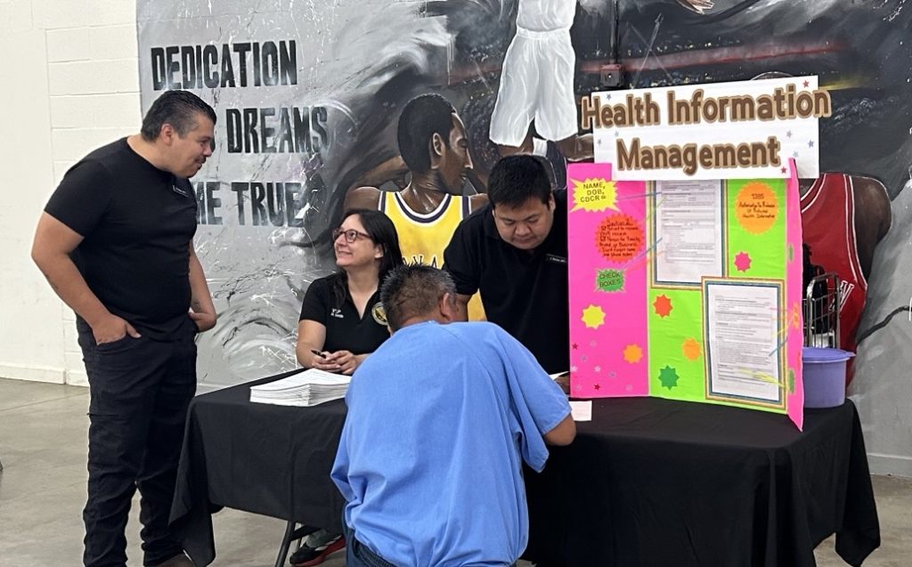 An incarcerated person fills out a form at the VSP wellness fair.