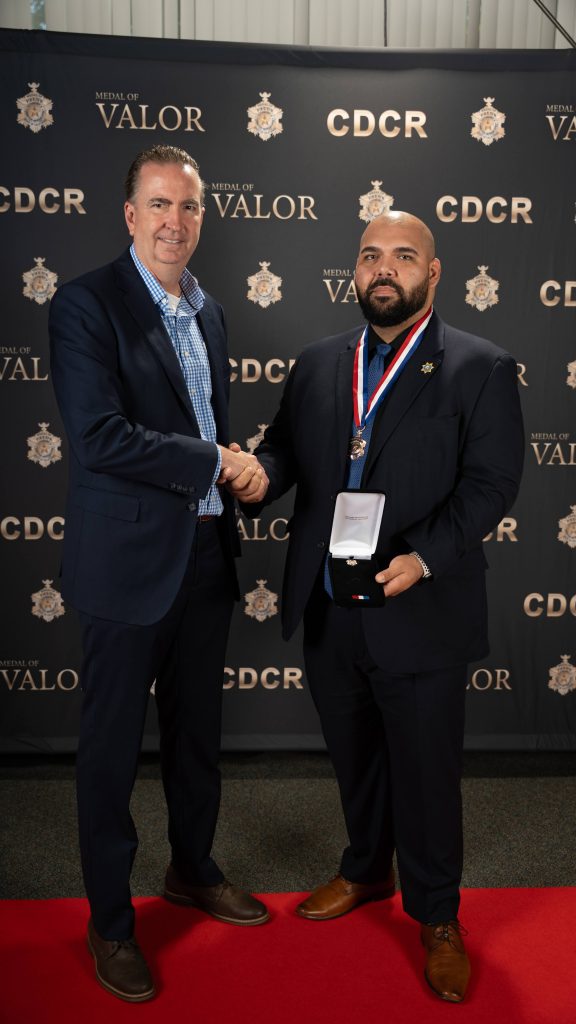 Secretary with MOV honoree Agent Yciano.