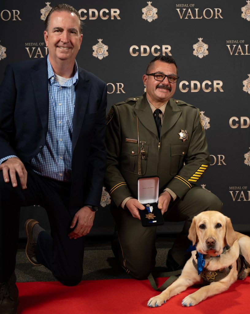 Officer Grady with K-9 Anna and Secretary Macomber.