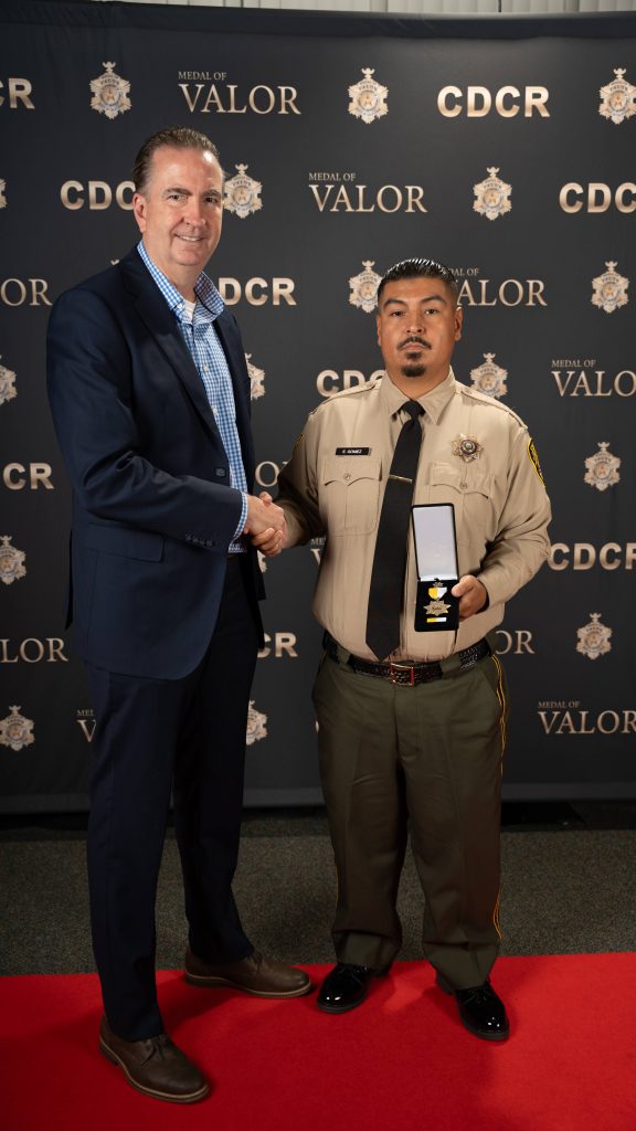 Bronze star honoree with Secretary Macomber at the MOV 2026.
