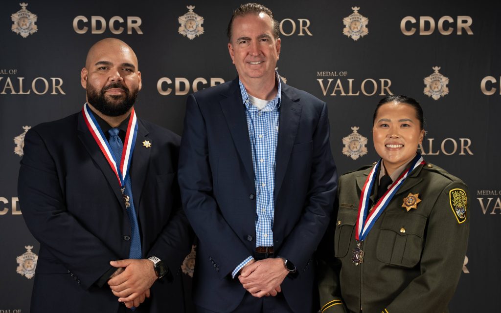 CDCR Secretary Jeff Macomber is flanked by Medal of Valor honorees Parole Agent Marcello Yciano and Correctional Officer Teng Thao.