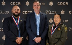 CDCR Secretary Jeff Macomber is flanked by Medal of Valor honorees Parole Agent Marcello Yciano and Correctional Officer Teng Thao.