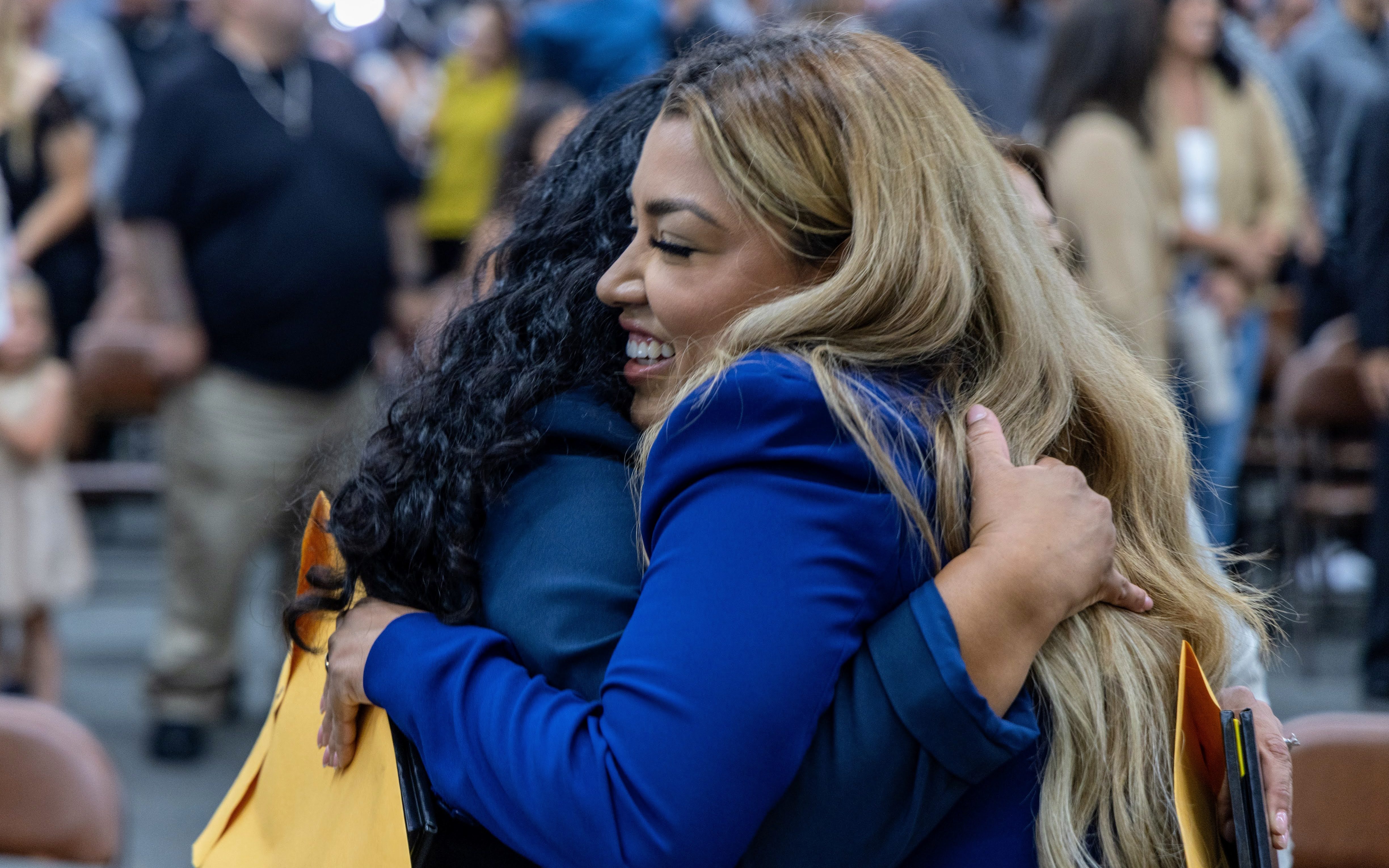 Agents hugging after ceremony.