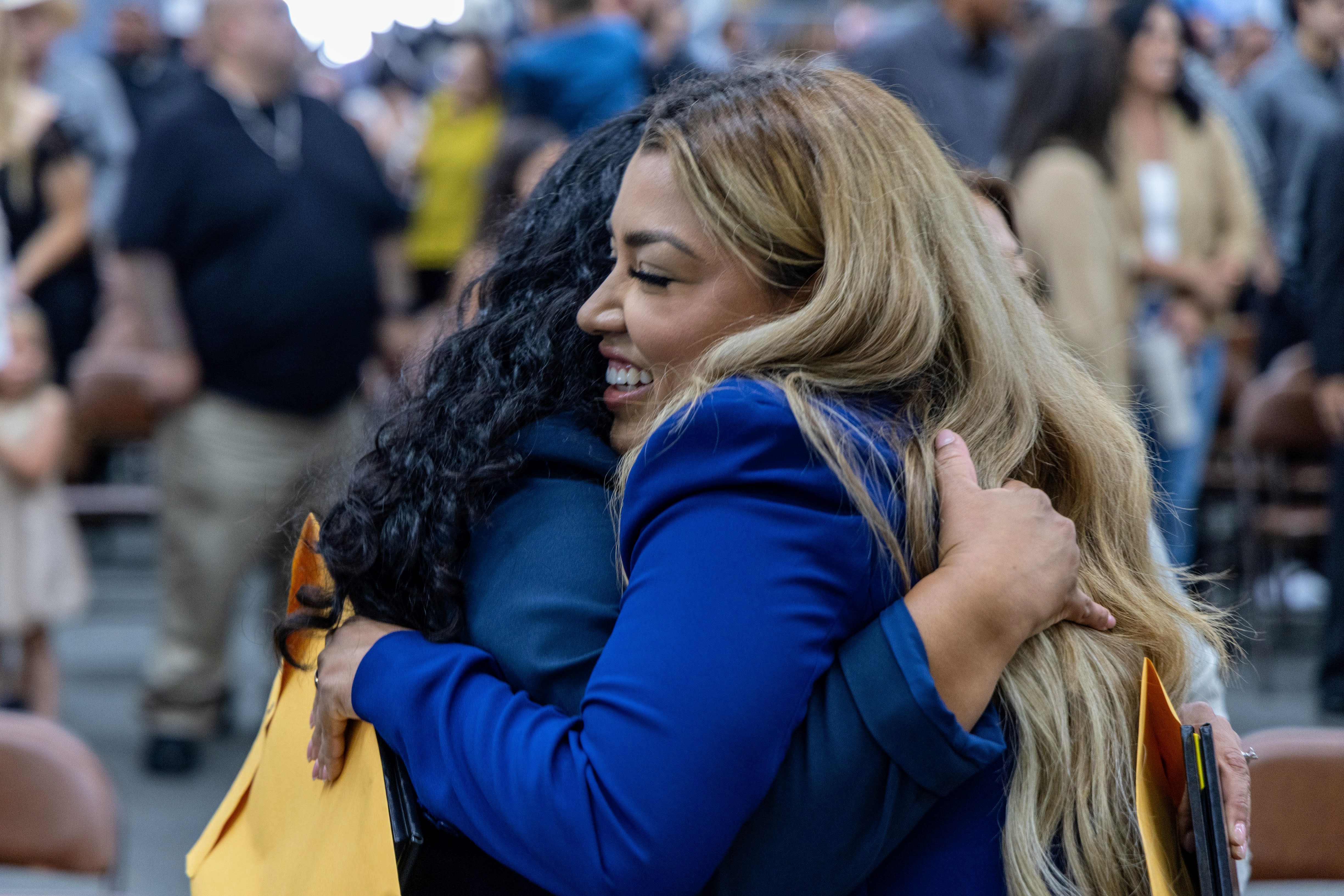 Agents hugging after ceremony.