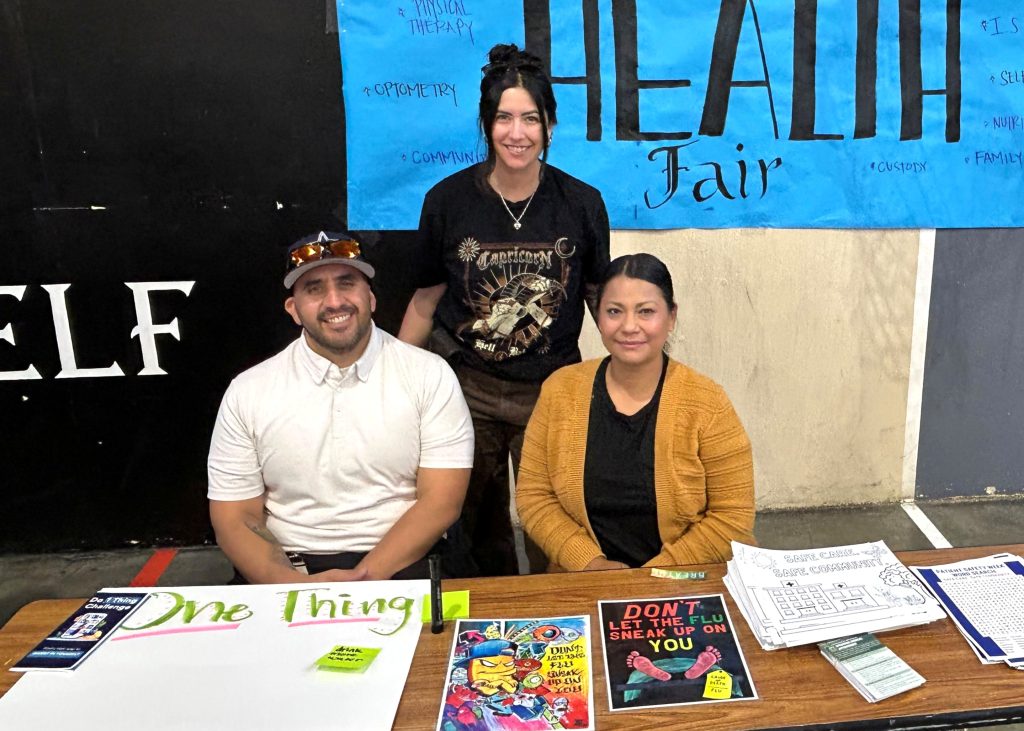 Resource table with staff at ASP health and wellness fair