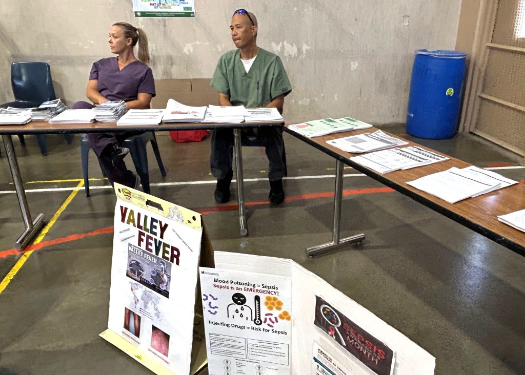 Resource table with staff at ASP health and wellness fair