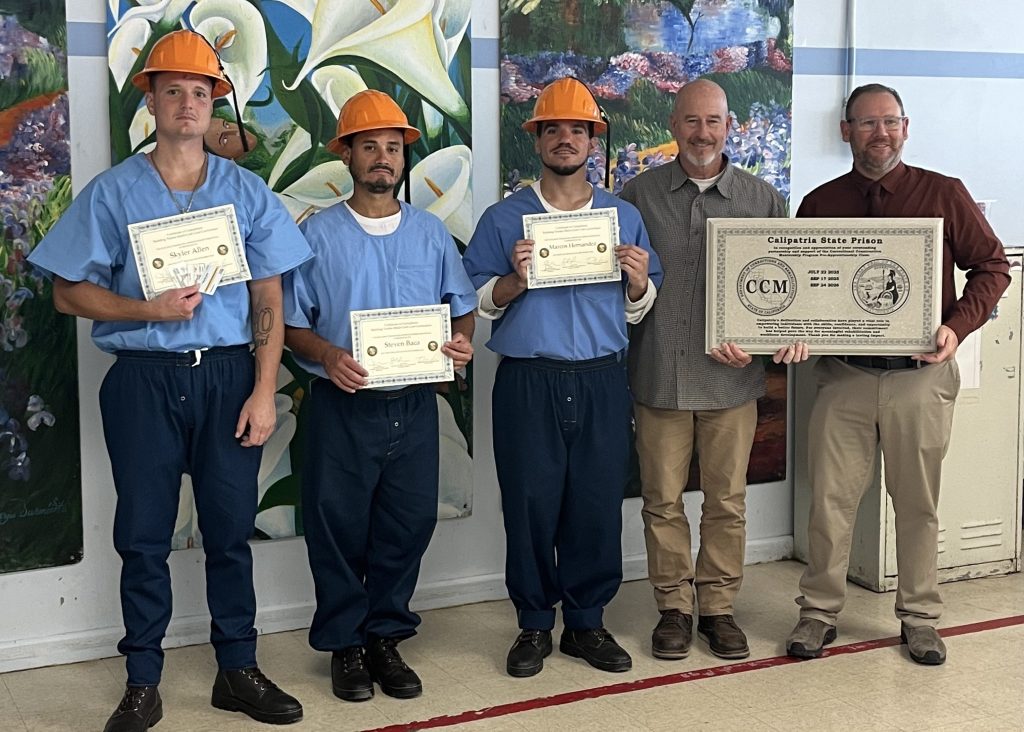 California State Prison, Corcoran staff and incarcerated graduates with certificates for completing the Correctional Construction Mentorship pre-apprenticeship program