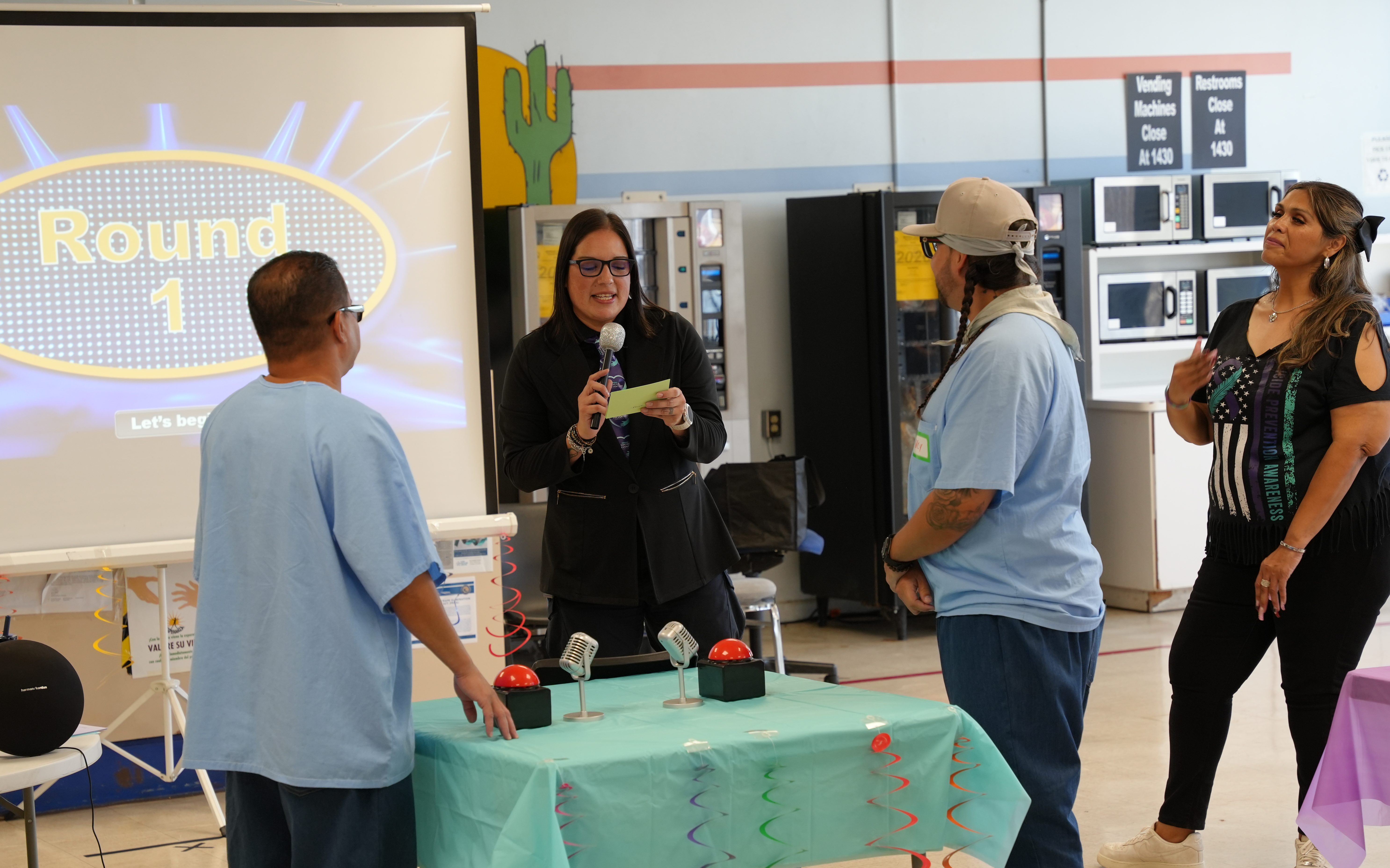 A staff member moderates a Family Feud style game for the incarcerated population at Calipatria State Prison.