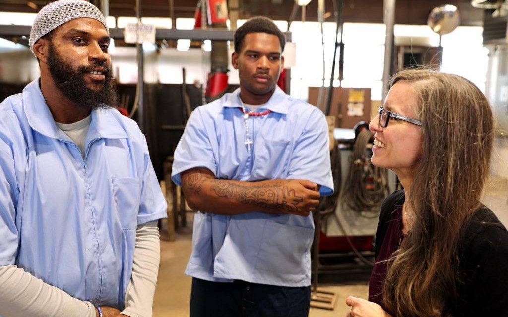 Suzie Changus, Director of CALCTRA, discusses the new Ironworkers Pre-Apprenticeship Program with incarcerated students at CIM.