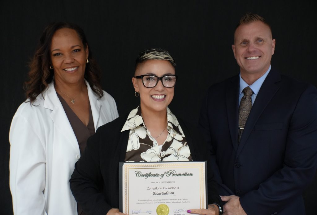 A staff member holds her certificate at CHCF.