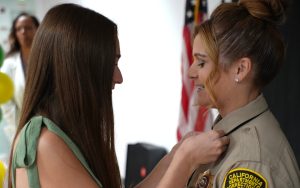 A female custody staff member has her rank insignia pinned to her collar during a promotional ceremony at the California Health Care Facility in Stockton, June 26, 2026.