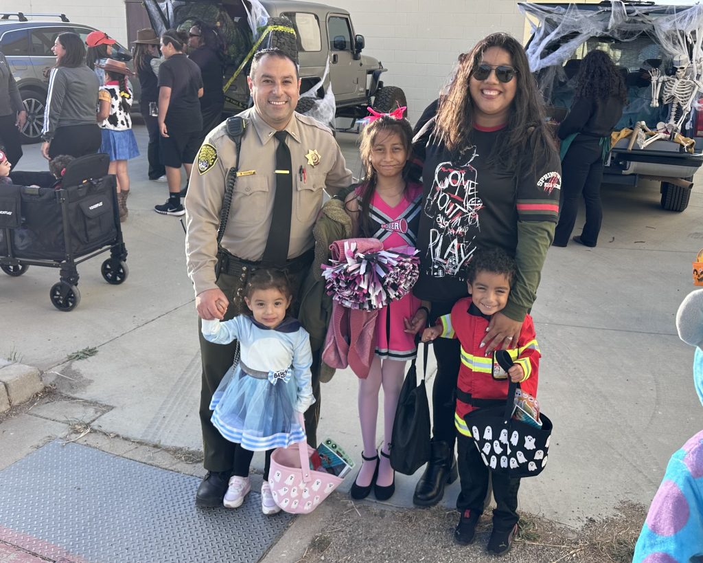 Costumed family with their correctional officer staff member at CTF-Soledad.