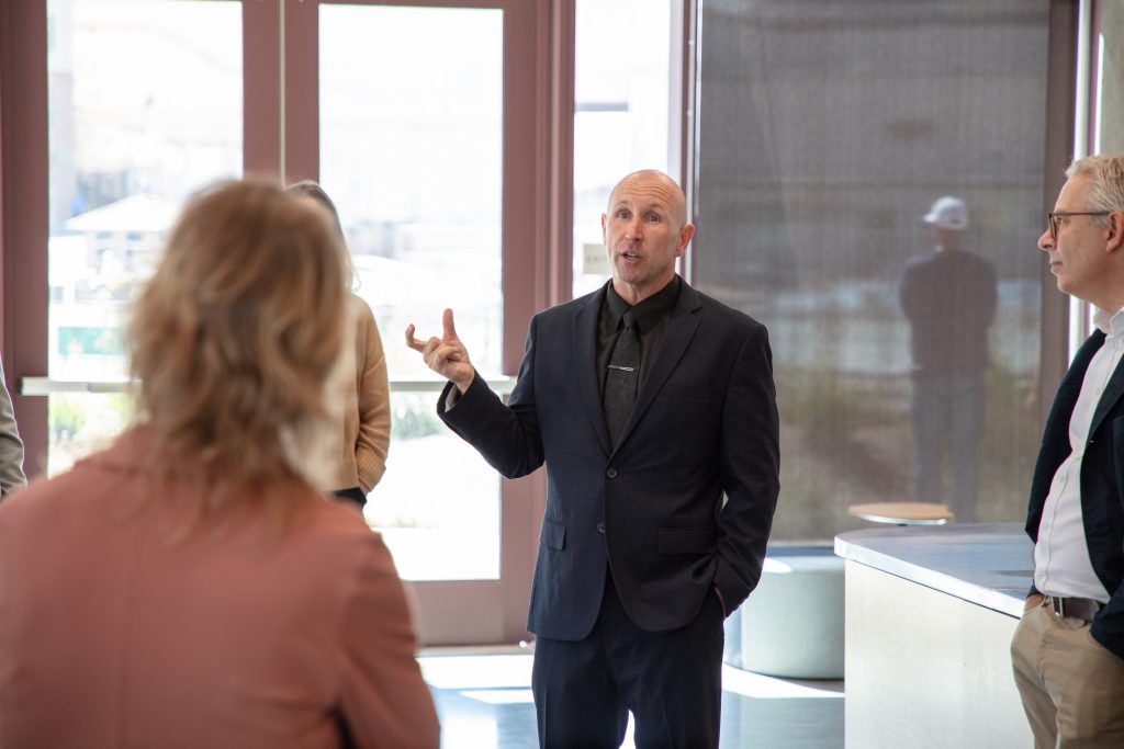 San Quentin Warden Chance Andes speaks with the visitors as they tour the new learning center campus.