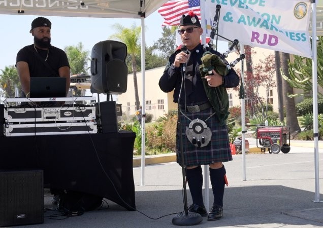 Bagpipe player at RJD for Suicide Awareness Month, connecting staff with community resources.