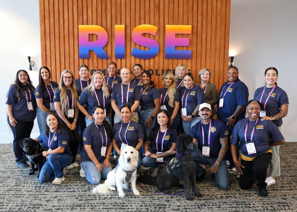 CDCR staff in large group photo in front of the RISE sign at convention