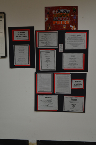 Essays and poems displayed on wall