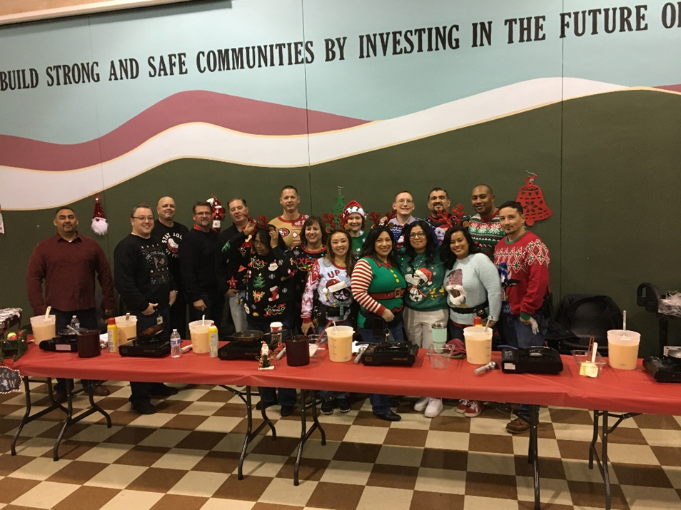 NAC managers and DJJ executive staff pause for a quick photo before serving NAC staff a holiday breakfast. 
