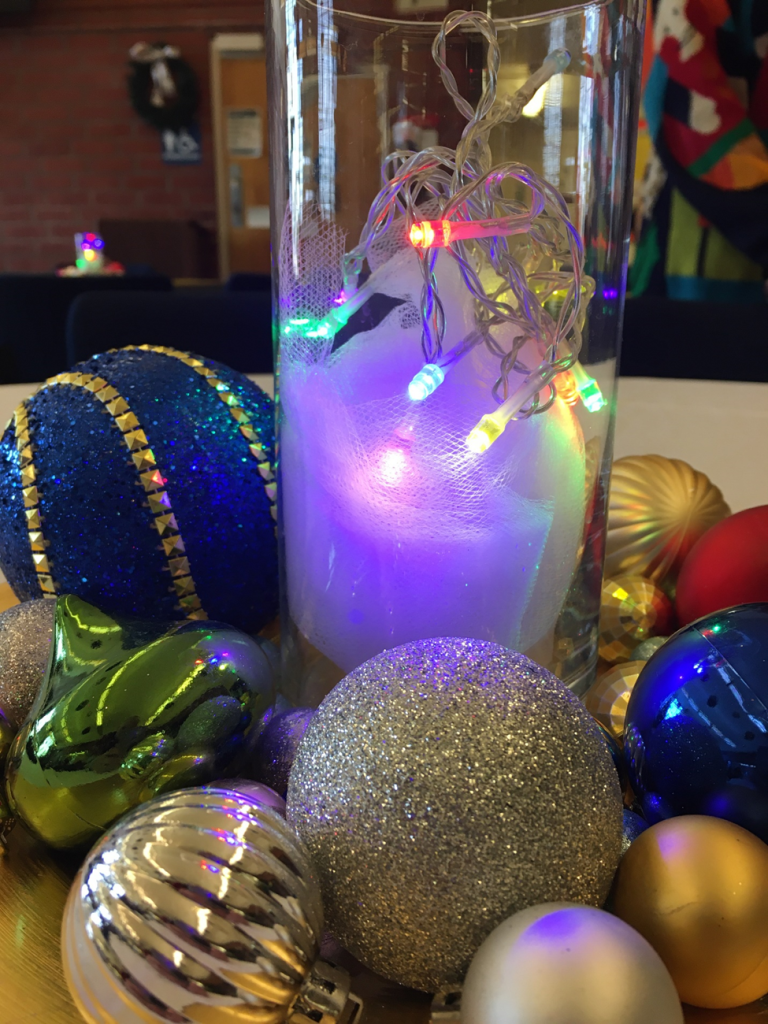 A holiday centerpiece of Christmas balls and lights. 