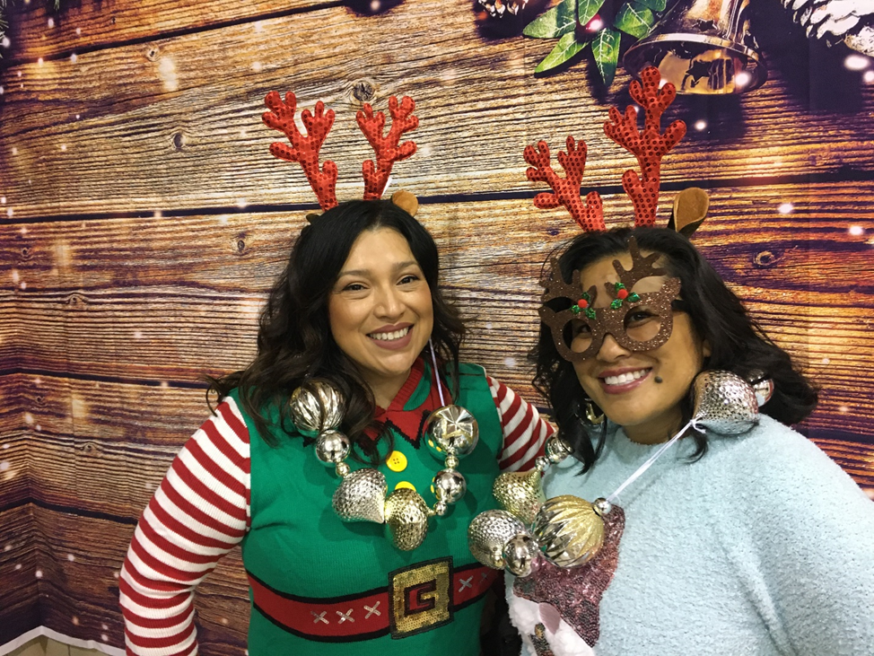 PA Bianca Lopez (left) and CWS Christina Natividad-Pham (right) organized holiday cheer at NA Chaderjian Youth Correctional Facilty in Stockton, complete with a photo backdrop area and holiday props. 