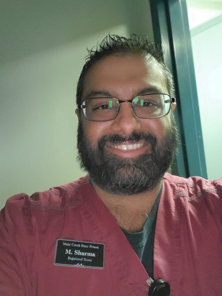 A bearded man in scrubs.