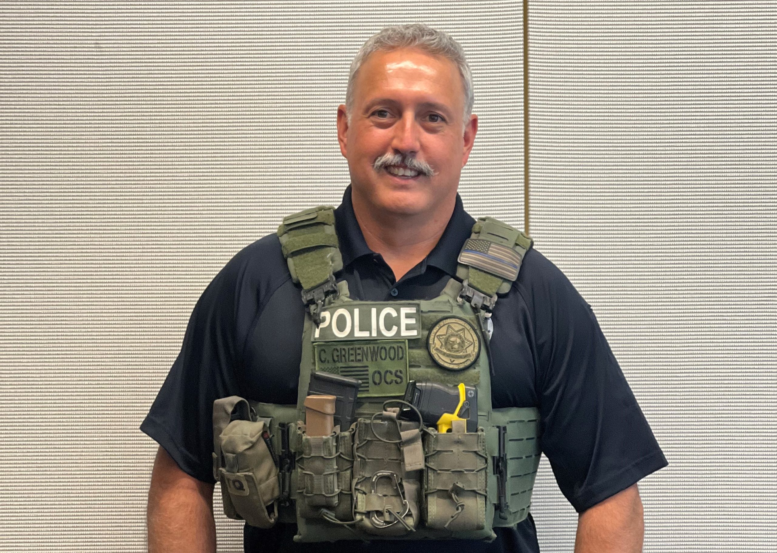 Chad Greenwood wearing police vest and gear.