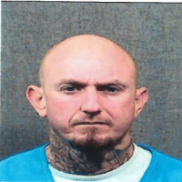 Bobby Gleason white male, 5’ 10”, 160 pounds, shaved head (black/brown hair), blue eyes and was lst seen with a mustache and goatee.  Gleason has multiple tattoos on his neck, hands, arms, legs and torso.