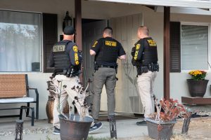 Parole Agents visit an active parolee's home during Operation Boo