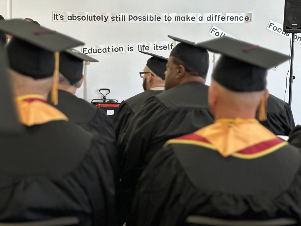 Incarcerated graduates receive their associate's degree during a ceremony at RJD