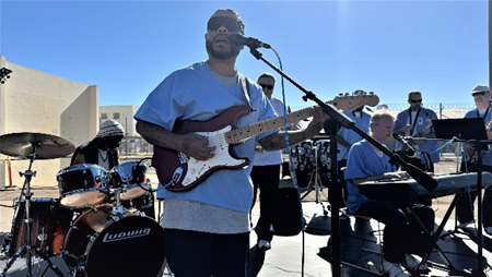 An incarcerated individual playing in a band