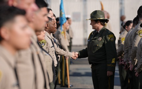 Instructor shaking hands with cadets