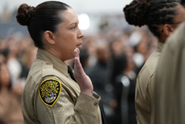 Officers with raised right hand during the swearing in
